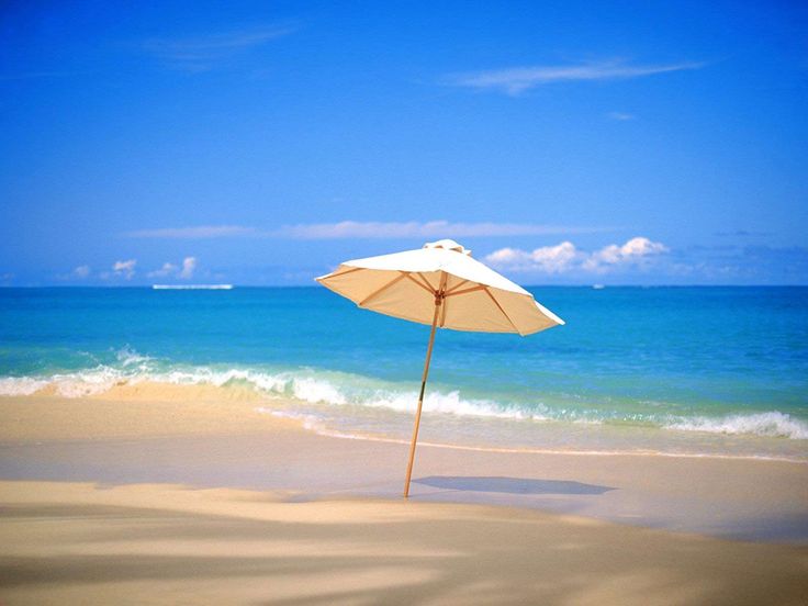 an umbrella sitting on top of a sandy beach next to the ocean with words fit for summer