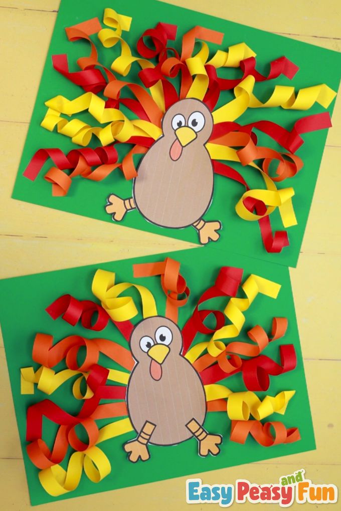 two paper turkeys with streamers on them