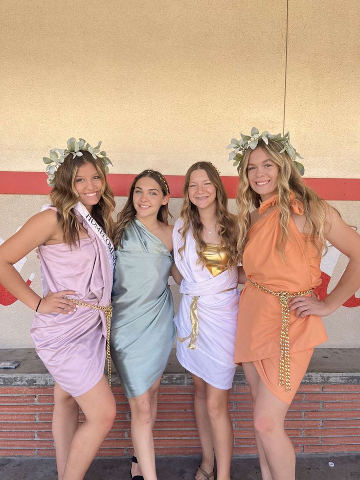 three women in dresses posing for a photo together with one woman wearing a flower crown on her head