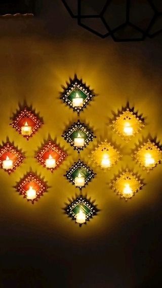 many lit candles are arranged on the wall