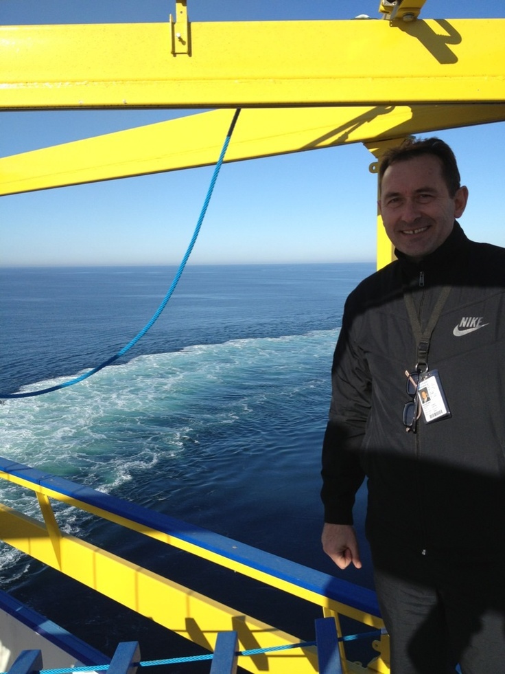 a man standing on the deck of a boat