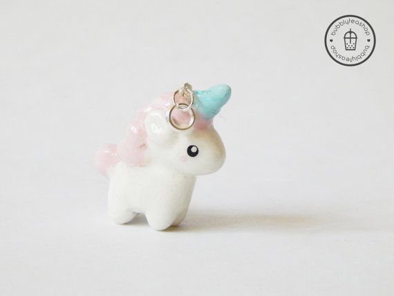 a small white pony with a pink and blue horn on it's head is standing in front of a white background