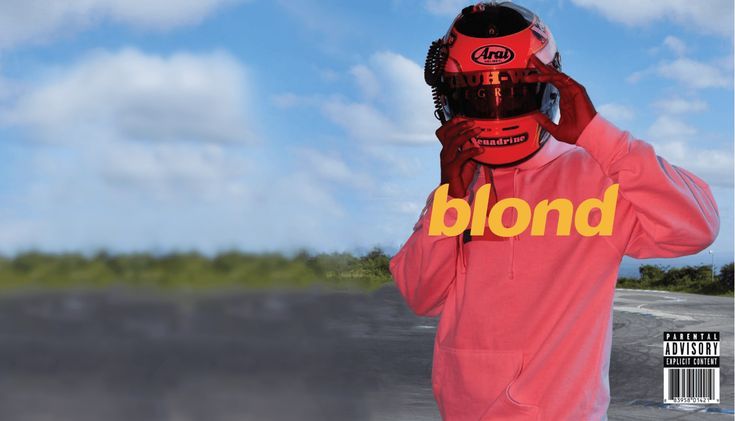 a man wearing a helmet and holding his hands up to his face with the word blond written on it