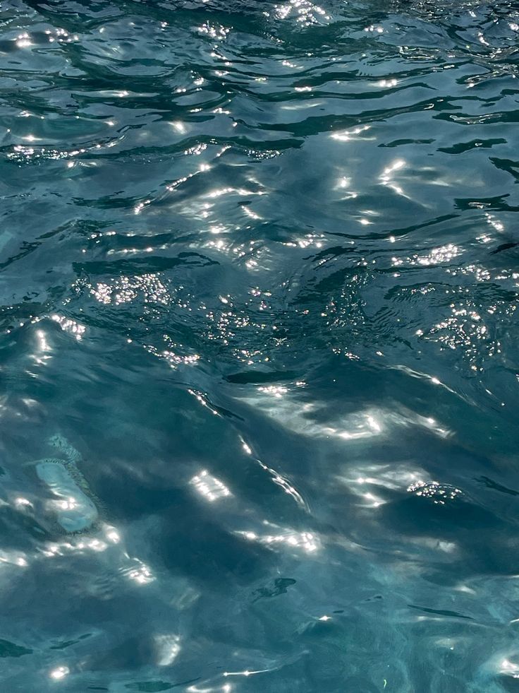 the water is very blue and clear with little ripples on it's surface