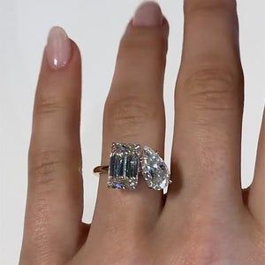 a woman's hand with a ring on it and an oval shaped diamond in the middle