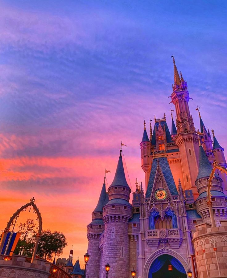 the castle is lit up at night with its lights on