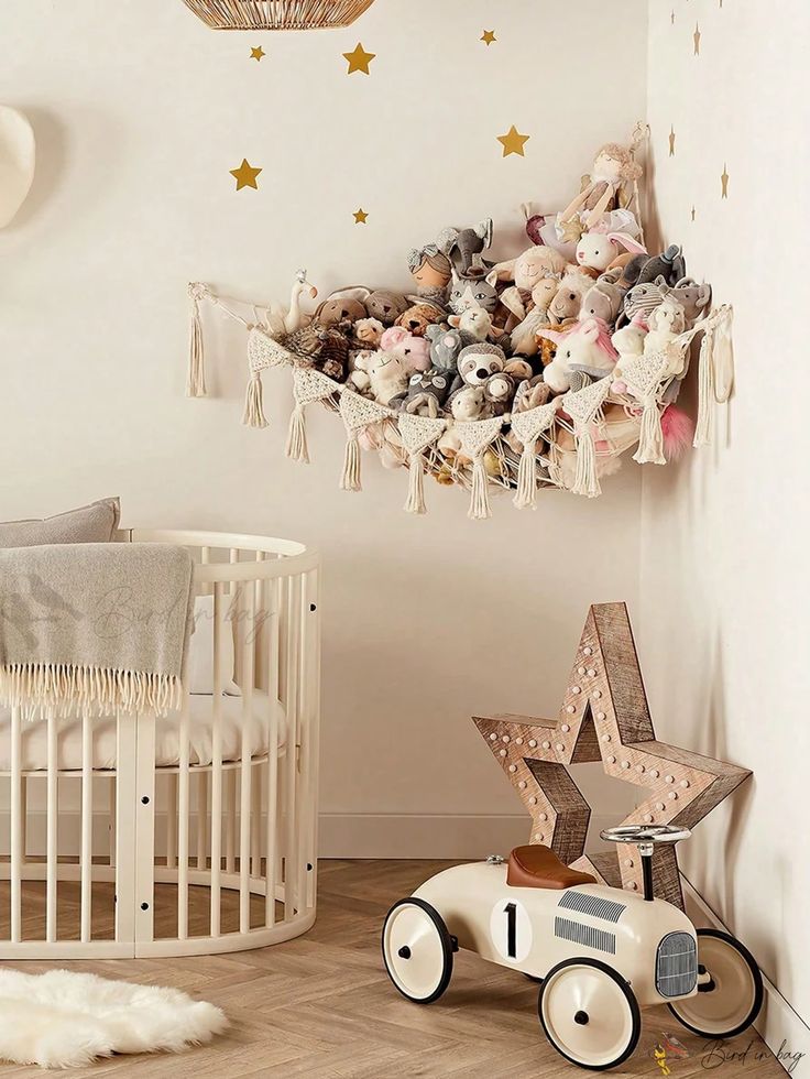 a baby's room with teddy bears and stars hanging from the ceiling, including a crib