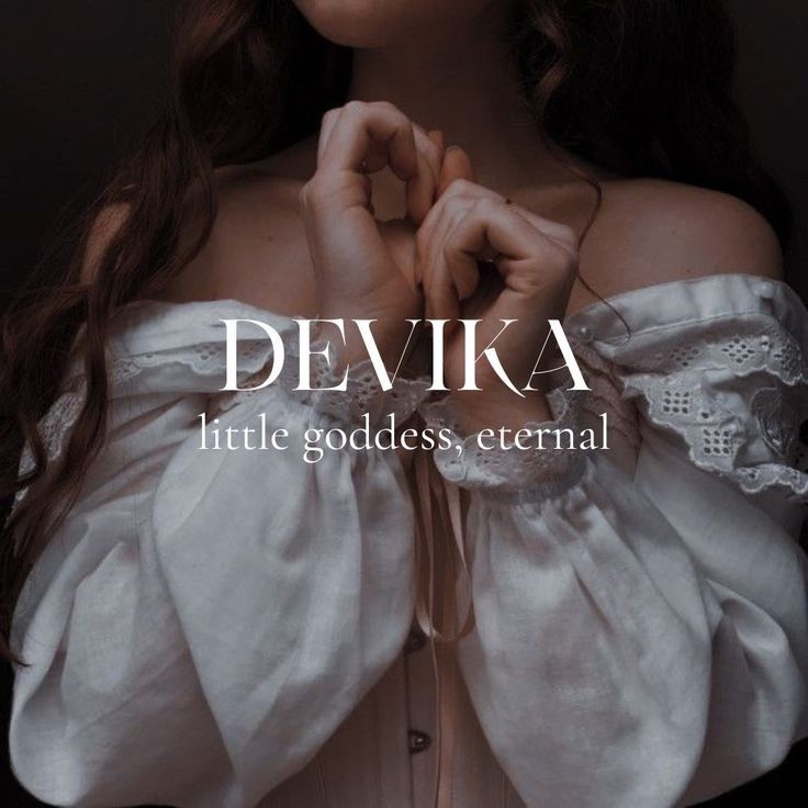 a woman wearing a white dress with her hands on her chest and the words devika written below it