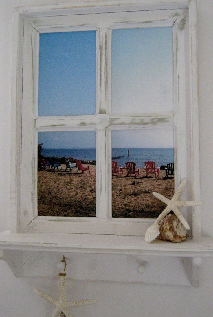 a starfish is sitting on the ledge of a window in a room with white walls