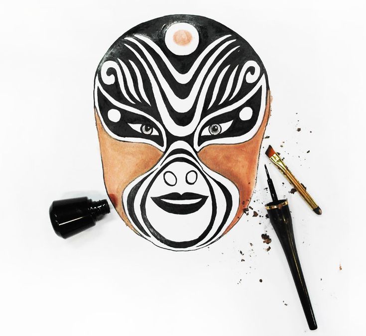 a drawing of a mask with black and white designs on it next to a pen