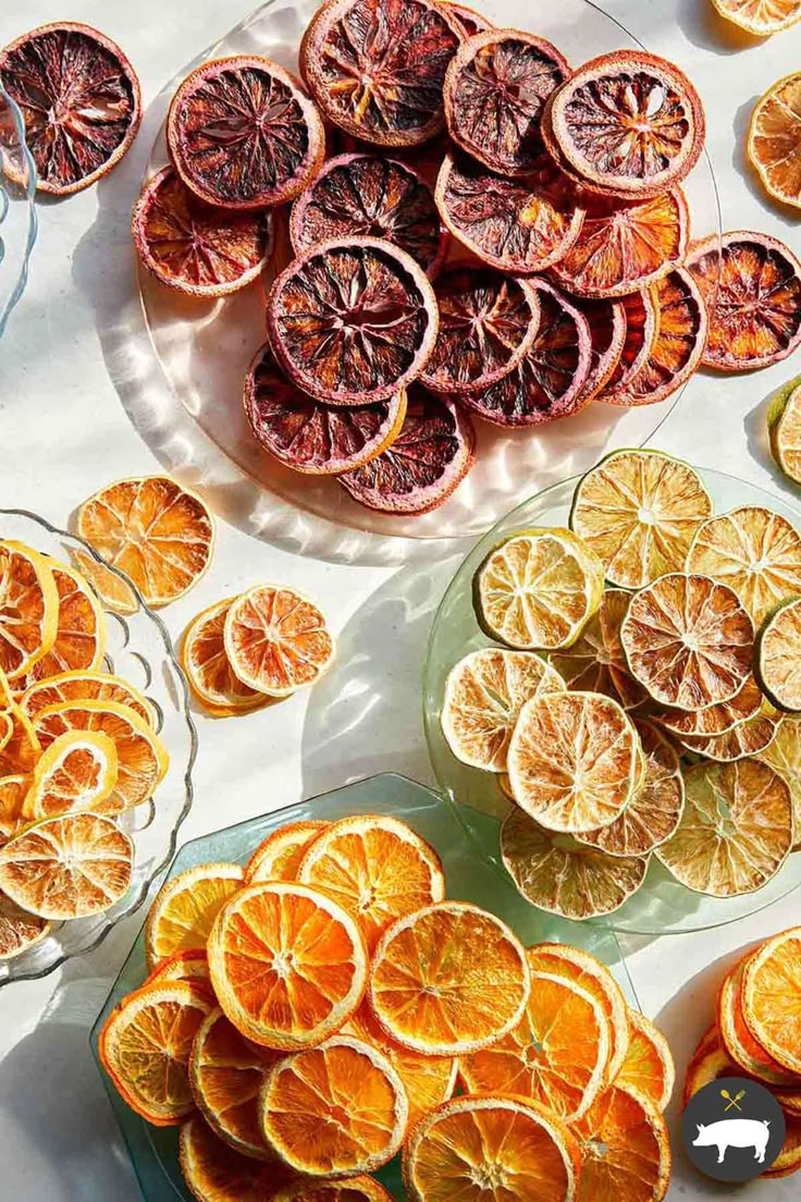 sliced oranges are arranged on glass plates