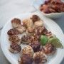 there is a white plate with food on it and two bowls full of fruit in the background