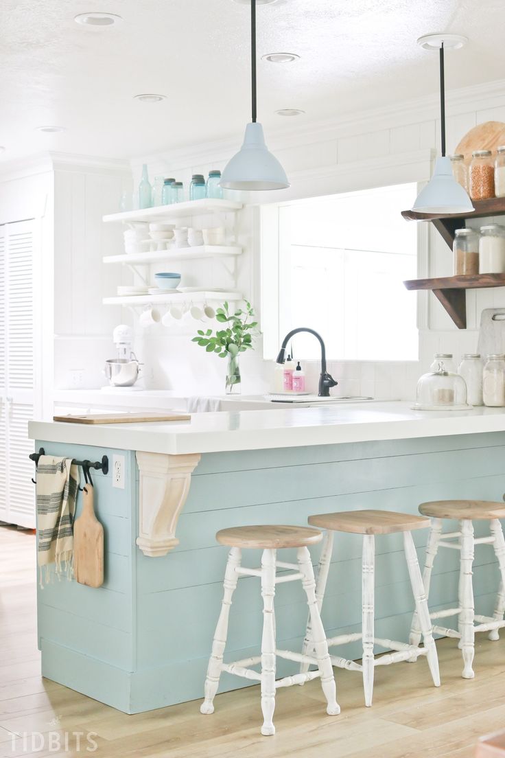 a kitchen island with three stools in front of it and the words saved all on