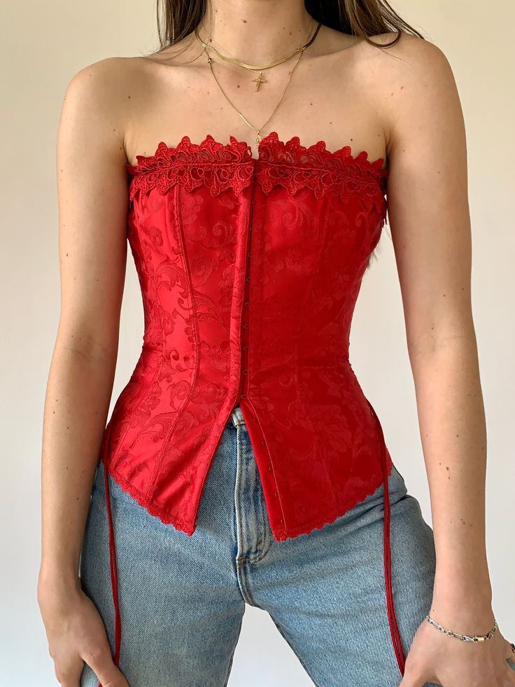 Y2K Frederick’s of Hollywood corset. Strapless fit with eye and hook front closure and lace-up back. In red with floral detail. Material is polyester. In excellent condition. Tagged size 32, best fits sizes XS-S. Adjustable fit due to lace up closure. Y2k Corset, Thrift Y2k, Frederick’s Of Hollywood, Corsets And Bustiers, Waist Cincher, Bohemian Fashion, Bustier Top, Bustiers, Corsets