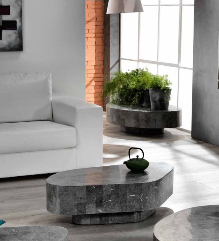 a living room filled with white furniture next to a wall mounted planter and potted plants