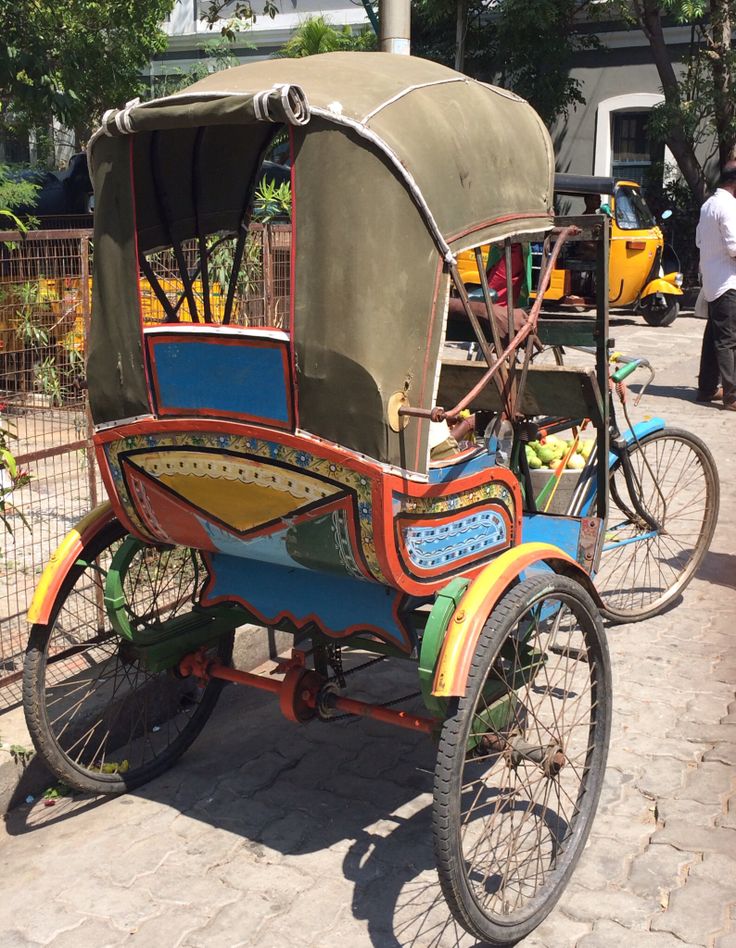 an old fashioned tricycle is parked on the street