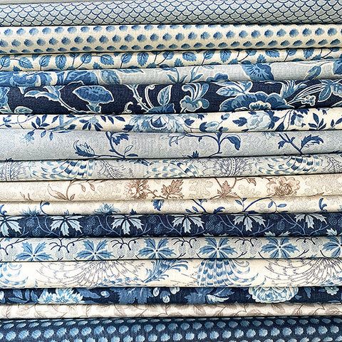 a stack of blue and white fabrics on top of each other in different sizes, shapes and colors