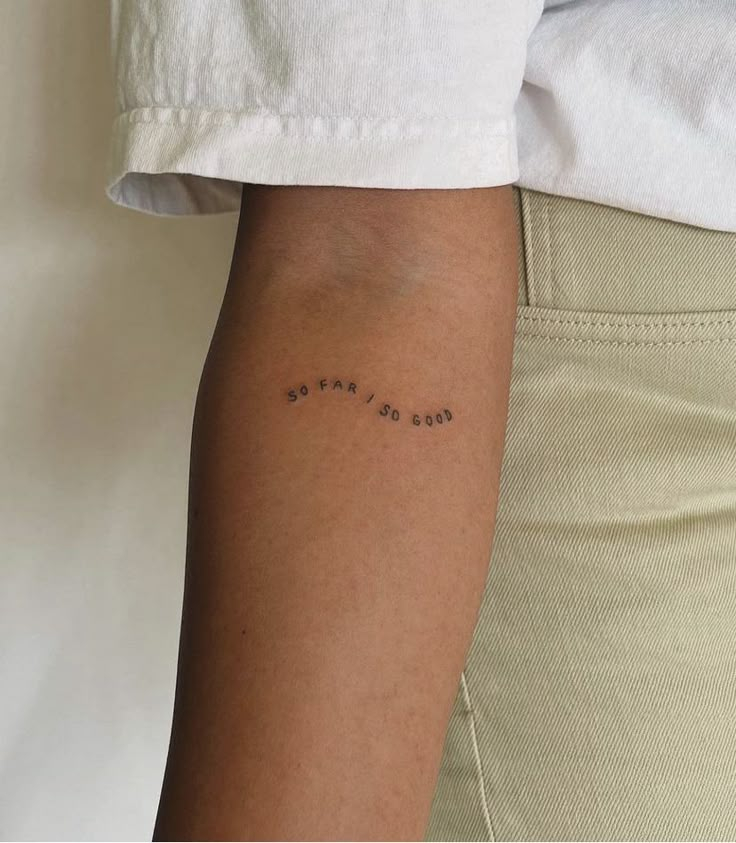 a person with a tattoo on their arm that says, love is all you need