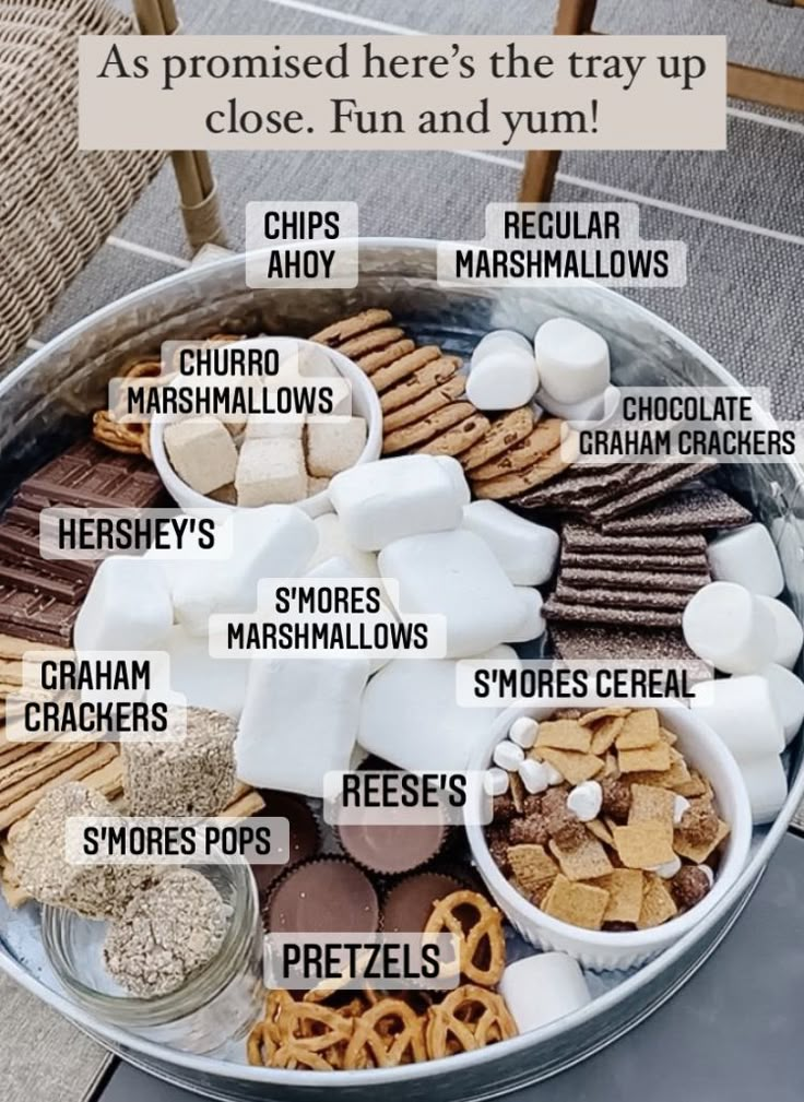 a metal bucket filled with lots of different types of snacks on top of a table