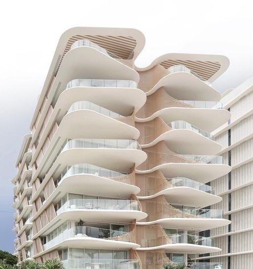 a large building with many balconies on the top and bottom floors that are shaped like waves