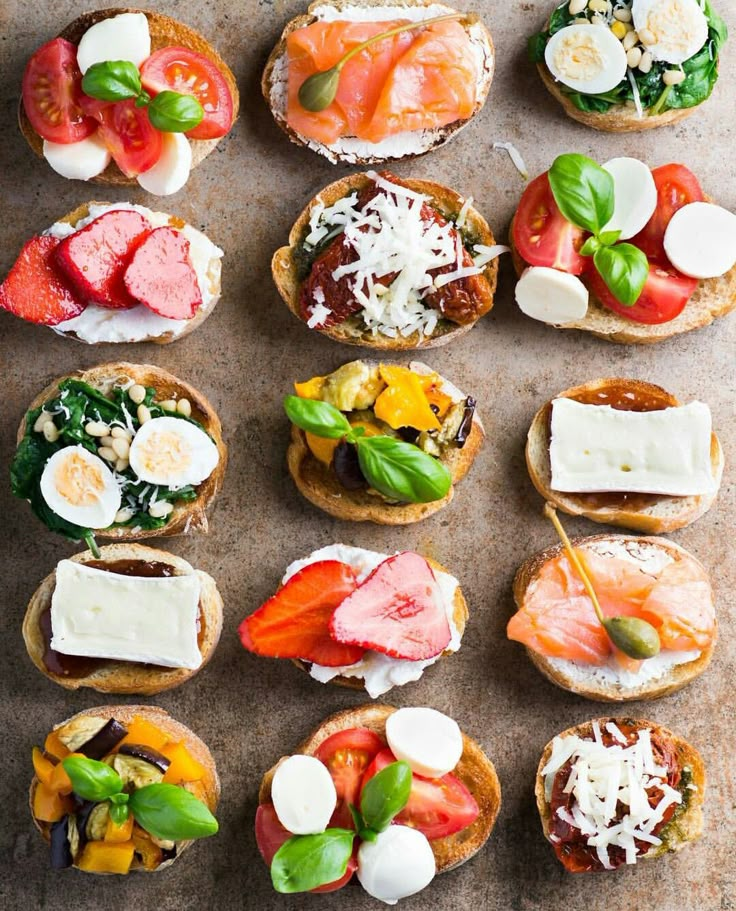 small sandwiches with different toppings are arranged on top of each other, including tomatoes and mozzarella