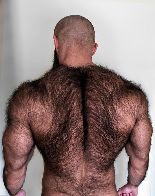 the back of a man with no shirt on, showing his hairy body and chest