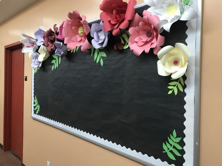 a bulletin board with paper flowers on it