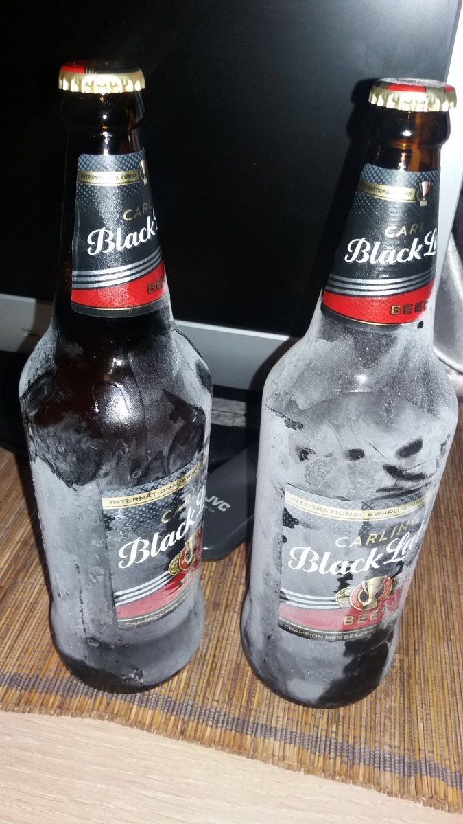 two bottles of beer sitting next to each other