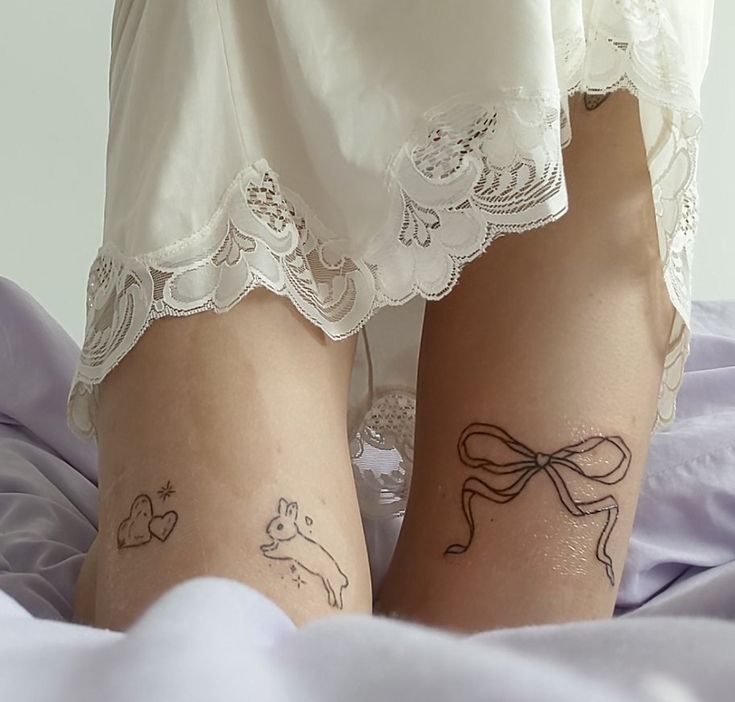 two women with tattoos on their legs