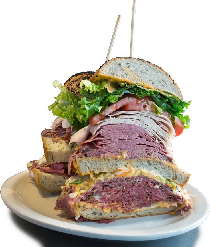 a large sandwich with meat and lettuce on a plate