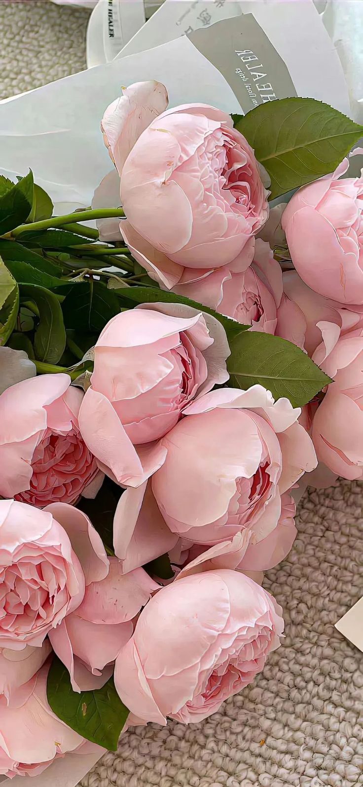 a bunch of pink flowers sitting on top of a table