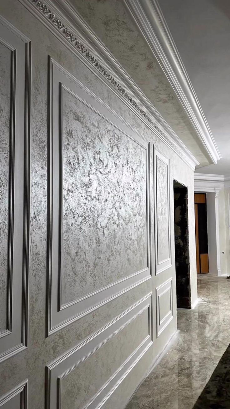 an empty room with white walls and marble floors