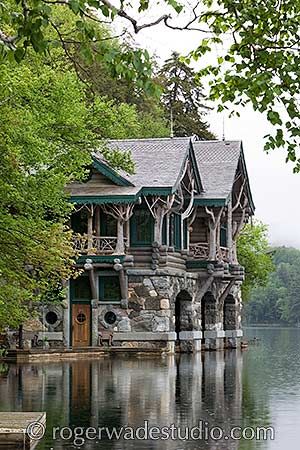 an old stone house sitting on top of a lake