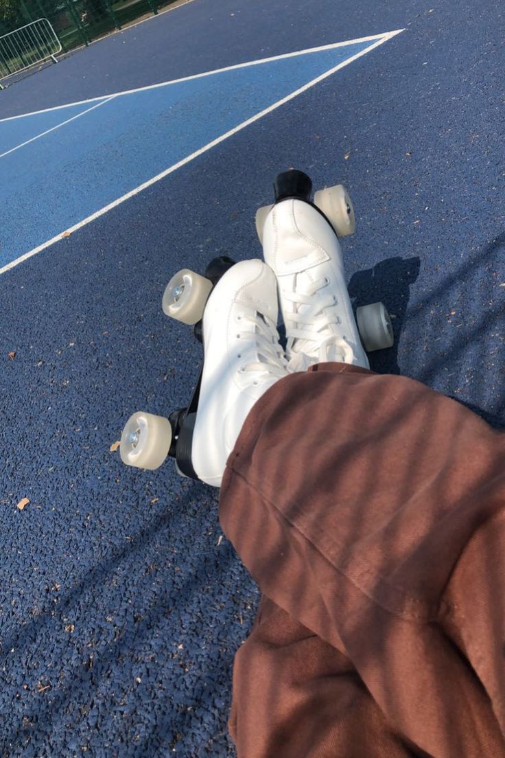 a person with their feet on the ground next to a skateboard