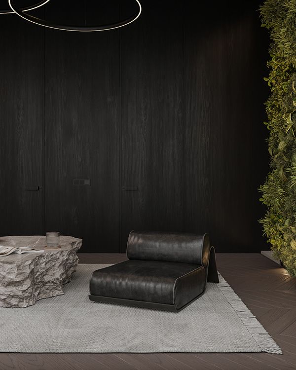 a living room with black walls and leather furniture