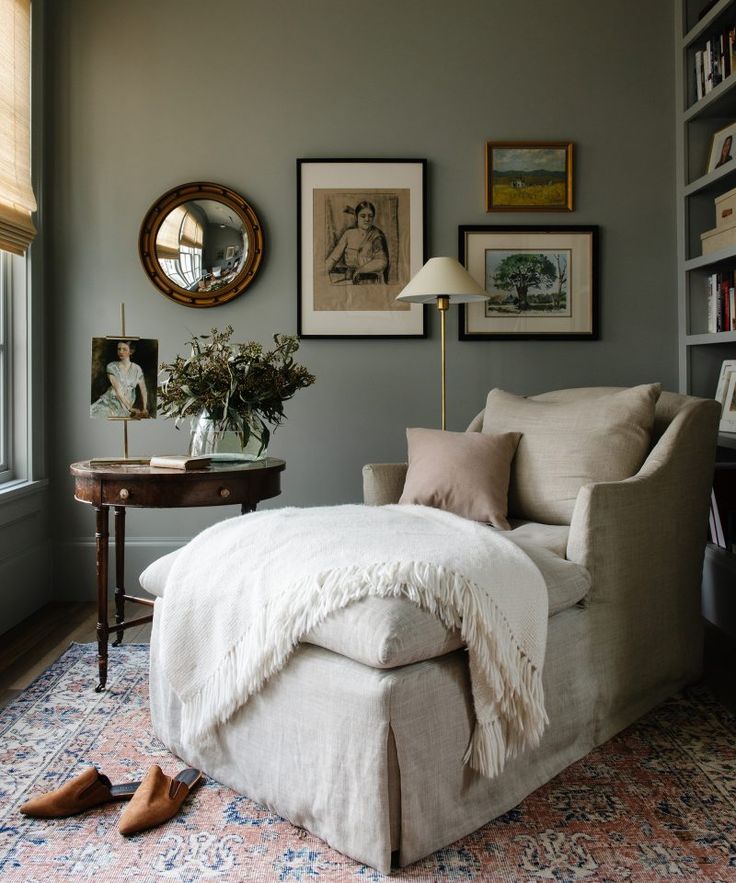 a living room filled with furniture and pictures on the wall