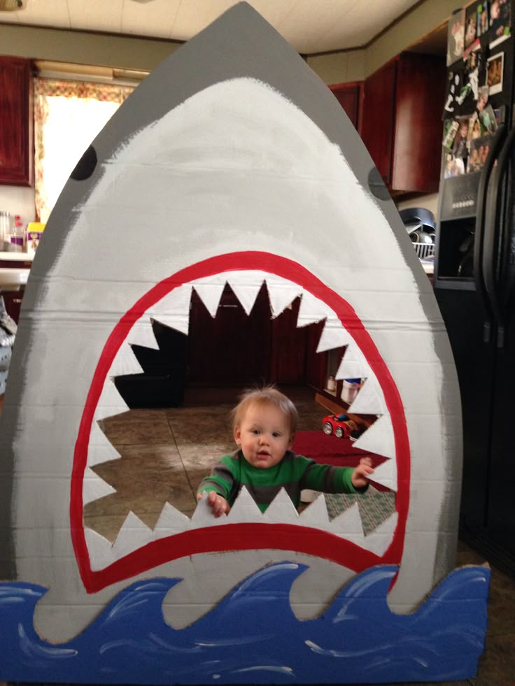 a child in a fake shark costume