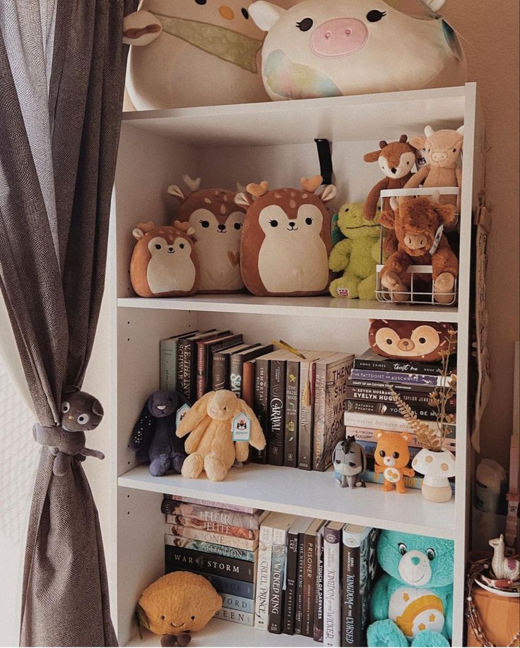 there are many stuffed animals on the shelves in this children's bookcases