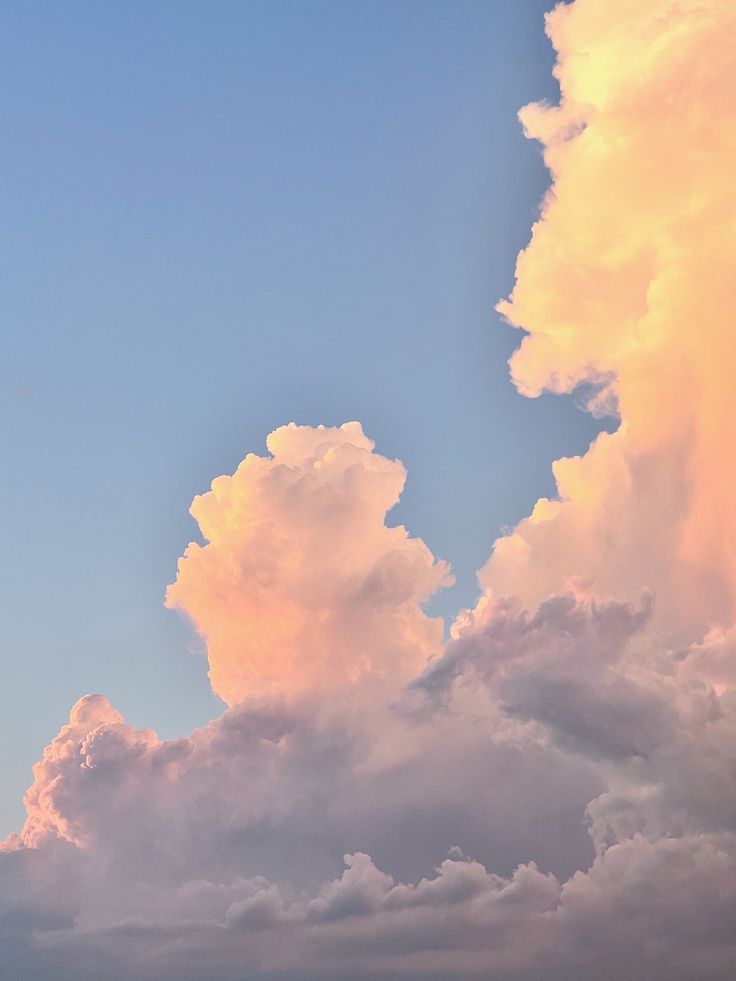 the airplane is flying high in the sky above the clouds at sunset or sunrise time