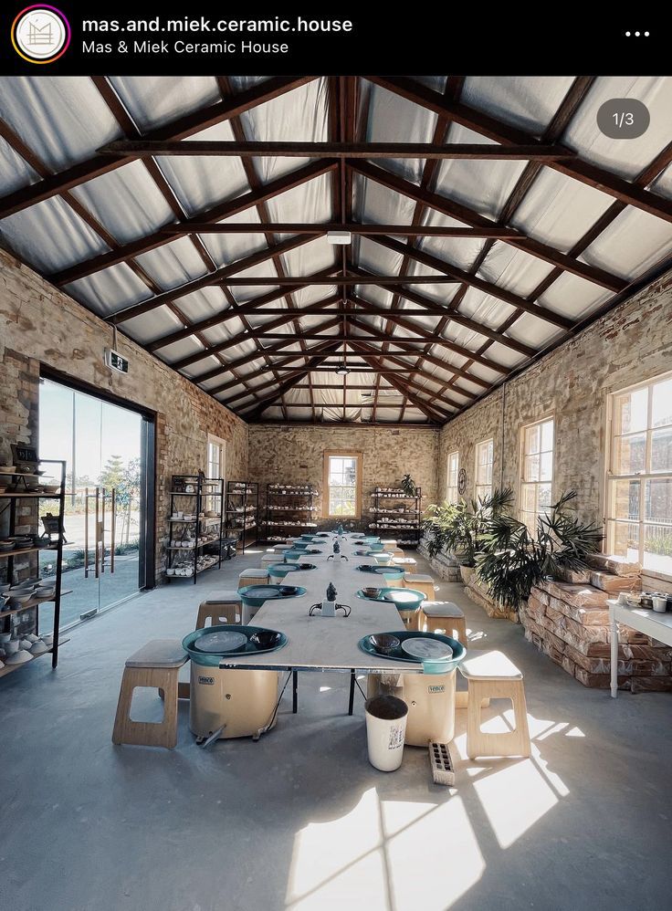 a large room with tables and chairs inside of it's walls covered in stone