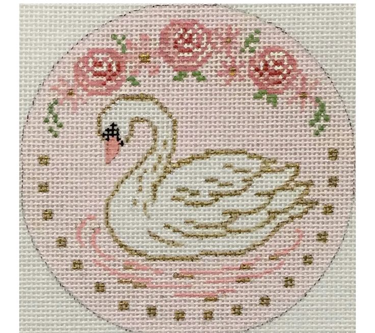 a cross stitch swan with roses on it