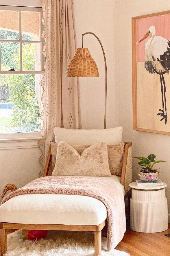 a bedroom with a bed, chair and painting on the wall in it's corner