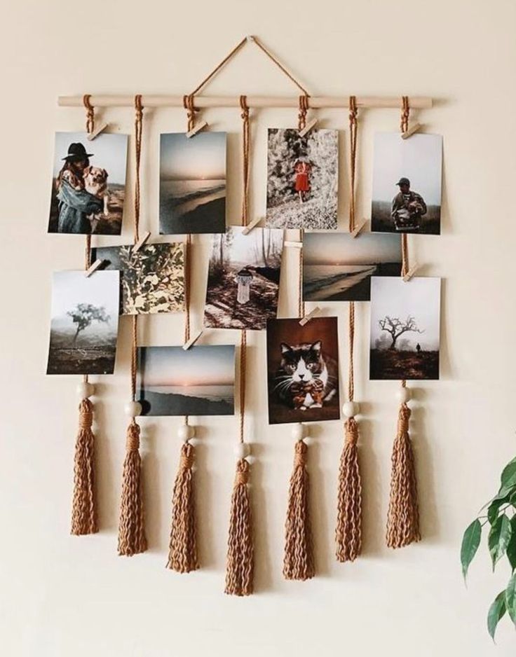 a wall hanging with pictures and tassels on it