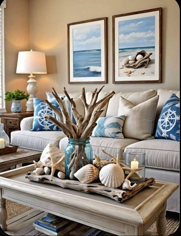 a living room filled with furniture next to a window covered in blue and white pillows