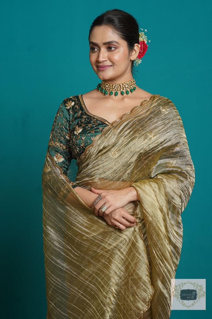 1.Fabric: Zari Tissue 2.Work: The saree borders have been scalloped using fine cutdana beads and zari. 3.Colour: Ash Green 4.Length: 5.5 metre Width: 43 inches approx 5.Blouse piece: Unstitched Colour: Emerald Green Fabric: Crepe Silk Length: 1 metre Work: embroidered heavily on the front,back and sleeves using colourful sequins,pearls and cutdana in floral pattern. Swipe for picture. 6.Care: DRY WASH ONLY. NEVER WASH EMBROIDERED FABRICS. 7.Despatch Time: 12-15 days. What You will Recieve: 1 Sar Cocktail Saree, Emerald Green Fabric, Saree Borders, Scalloped Blouse, Golden Saree, Tissue Saree, Saree Border, Satin Saree, Green Saree