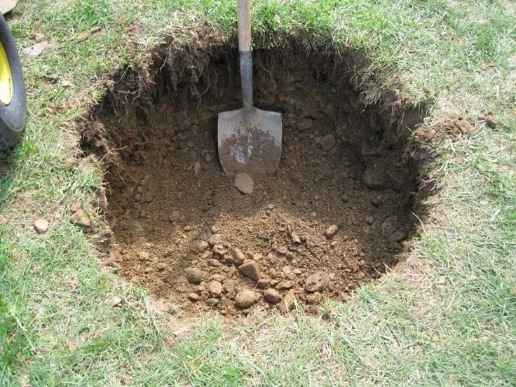 there is a hole in the ground with a shovel