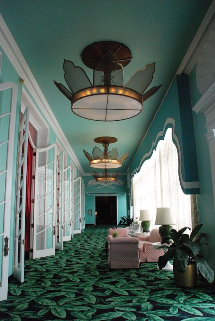 the hallway is decorated in green and blue with white trimmings on the walls