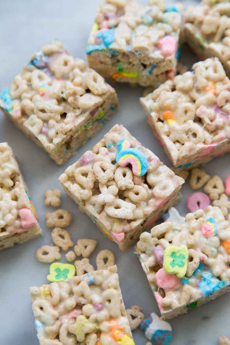 cereal krispy kreme treats are arranged on a white surface with colorful sprinkles