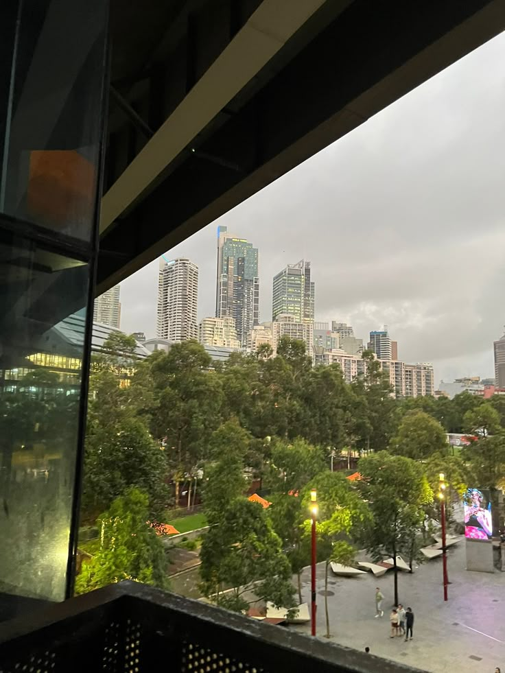 the city skyline is seen through an open window in this view from inside a building