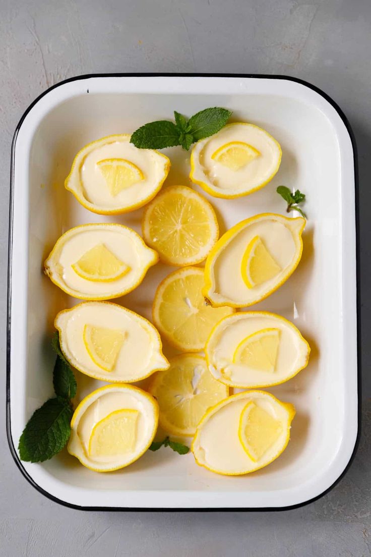 sliced lemons and mint in a white dish